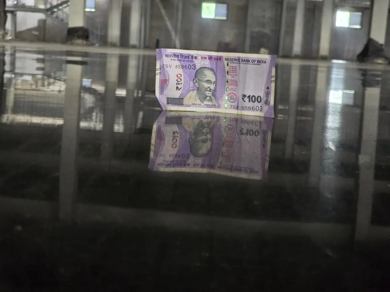 ₹100 note reflected on a mirror-finish polished concrete floor by Gangadhar Concrete Solution